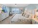 Bright bedroom with light colored walls and water views features a ceiling fan and comfortable king bed at 4601 S Atlantic Ave # 7030, Port Orange, FL 32127