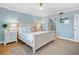 Bright bedroom with ensuite bath features calm color palette and hardwood flooring at 4601 S Atlantic Ave # 7030, Port Orange, FL 32127