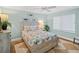 Bright bedroom features a coastal theme with wood-look floors and a queen bed at 4601 S Atlantic Ave # 7030, Port Orange, FL 32127