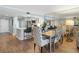 Open dining area with modern table set and adjacent breakfast bar flows to the kitchen in this condo at 4601 S Atlantic Ave # 7030, Port Orange, FL 32127