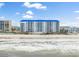 Oceanside building with direct beach access on a sunny day under a bright blue sky at 4601 S Atlantic Ave # 7030, Port Orange, FL 32127