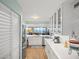 Galley kitchen leading to living area featuring stainless appliances and ample countertops at 4601 S Atlantic Ave # 7030, Port Orange, FL 32127