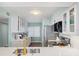 Well-lit kitchen with white cabinets, stainless steel appliances, and elegant countertops at 4601 S Atlantic Ave # 7030, Port Orange, FL 32127