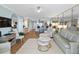 Open-concept living room with wood-look floors and views to the kitchen and dining areas at 4601 S Atlantic Ave # 7030, Port Orange, FL 32127