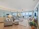 Bright living room with comfortable seating and balcony access offering beautiful ocean views at 4601 S Atlantic Ave # 7030, Port Orange, FL 32127