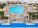 Aerial shot of a pool deck with lounge chairs, tables, and well-manicured landscaping at 4601 S Atlantic Ave # 7030, Port Orange, FL 32127