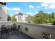 Cozy balcony with outdoor seating and a view of the surrounding neighborhood and blue skies at 4725 Anson Ln, Orlando, FL 32814