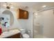 Traditional bathroom with an oak vanity, oval mirror and glass-enclosed shower at 4725 Anson Ln, Orlando, FL 32814