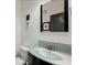 Stylish powder room with a unique glass sink, modern faucet, and decorative accents at 4725 Anson Ln, Orlando, FL 32814