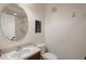 Modest bathroom featuring a toilet, sink, mirror and a glass enclosed shower at 4725 Anson Ln, Orlando, FL 32814