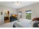 Cozy bedroom with two windows, TV, ceiling fan and access to an ensuite bathroom at 4725 Anson Ln, Orlando, FL 32814