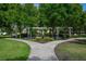 Relaxing community garden and sitting area with benches among manicured lawns and shady pergolas at 4725 Anson Ln, Orlando, FL 32814