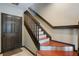 Entryway with beautiful staircase, wood floors, and a door at 4725 Anson Ln, Orlando, FL 32814