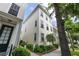 Side view of a well-maintained townhome with manicured landscaping and large windows for ample natural light at 4725 Anson Ln, Orlando, FL 32814