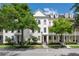 Charming townhome with beautiful curb appeal, featuring lush green trees and well-maintained landscaping at 4725 Anson Ln, Orlando, FL 32814