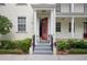 Inviting front entrance with a red door, decorative wreath, and well-maintained landscaping at 4725 Anson Ln, Orlando, FL 32814