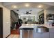 Open-concept kitchen with stainless steel appliances, a large island, and views of the staircase and living room at 4725 Anson Ln, Orlando, FL 32814