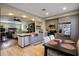 Open kitchen with stainless steel appliances, gray cabinets, and a dining area with views into the living room at 4725 Anson Ln, Orlando, FL 32814
