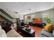Comfortable living room featuring hardwood floors, stylish furnishings, and a large TV at 4725 Anson Ln, Orlando, FL 32814