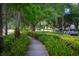 Scenic view of a meandering park path lined with lush greenery and mature trees in Baldwin Park at 4725 Anson Ln, Orlando, FL 32814