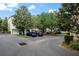 Photo of a parking lot for townhomes, surrounded by mature trees and well-maintained landscaping at 4725 Anson Ln, Orlando, FL 32814