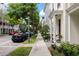 Street scene with beautiful townhomes, well-kept sidewalks, and lush green landscaping at 4725 Anson Ln, Orlando, FL 32814