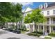 Attractive townhomes line a street with mature trees and parked cars, creating a vibrant neighborhood scene at 4725 Anson Ln, Orlando, FL 32814