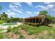 View of the pool and backyard with a covered lanai at 5001 Tangerine Ave, Winter Park, FL 32792