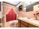 Charming pink bathroom with a tiled shower and vintage-style vanity sink at 5001 Tangerine Ave, Winter Park, FL 32792