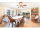 A dining room with hardwood flooring, a ceiling fan, sliding glass doors, and seating for six at 5001 Tangerine Ave, Winter Park, FL 32792