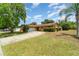 Charming single-story home featuring a two-car garage, mature landscaping, and a well-maintained lawn at 5001 Tangerine Ave, Winter Park, FL 32792