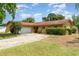 Charming single-story home featuring a two-car garage, mature landscaping, and a well-maintained lawn at 5001 Tangerine Ave, Winter Park, FL 32792