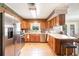 Eat-in kitchen features stainless steel appliances, wood cabinets, and bright countertops at 5001 Tangerine Ave, Winter Park, FL 32792