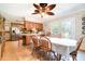 Traditional eat-in kitchen featuring tile floors, wood cabinets, and adjacent dining area with ceiling fan and lots of light at 5001 Tangerine Ave, Winter Park, FL 32792