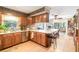 Eat-in kitchen features stainless steel appliances, wood cabinets, tile floor and breakfast bar at 5001 Tangerine Ave, Winter Park, FL 32792
