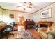Traditional living room with hardwood floors, ceiling fan, fireplace and views to kitchen at 5001 Tangerine Ave, Winter Park, FL 32792