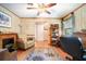 Cozy living room with fireplace, ceiling fan, and views to front entrance at 5001 Tangerine Ave, Winter Park, FL 32792