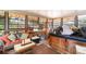 Bright sunroom with a wicker sofa and lots of natural light, perfect for relaxing at 5001 Tangerine Ave, Winter Park, FL 32792