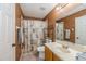 Neutral bathroom featuring a shower-tub, vanity sink, and decorative mirror at 502 Freeman St, Longwood, FL 32750