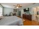 Large main bedroom with hard wood flooring, ceiling fan, and a dresser at 502 Freeman St, Longwood, FL 32750