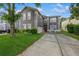 Charming two-story home with a well-manicured lawn, gray siding, and a concrete driveway at 502 Freeman St, Longwood, FL 32750