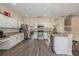 Open kitchen with white cabinets, granite countertops, stainless steel appliances, and durable laminate floors at 502 Freeman St, Longwood, FL 32750