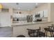 Bright kitchen with white cabinets, granite countertops, stainless steel appliances, and an island with breakfast bar at 502 Freeman St, Longwood, FL 32750