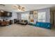 Spacious living room with multiple windows, a ceiling fan and plush carpeting at 502 Freeman St, Longwood, FL 32750