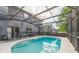 Backyard view of a screened-in pool with clear blue water and a safety fence at 502 Freeman St, Longwood, FL 32750