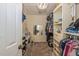 Organized walk-in closet with custom shelving, mirror, carpet and decorative light fixture at 502 Freeman St, Longwood, FL 32750