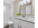 Bright bathroom featuring a white vanity with updated fixtures, a tub, and tiled shower walls at 507 Peach Tree Ln, Altamonte Springs, FL 32701
