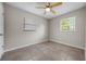An empty bedroom with neutral walls, tile floors, and natural lighting at 507 Peach Tree Ln, Altamonte Springs, FL 32701