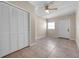 This neutral bedroom features a closet, window, and a ceiling fan at 507 Peach Tree Ln, Altamonte Springs, FL 32701