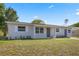 A home with a well-manicured lawn and an exterior in a neutral color palette at 507 Peach Tree Ln, Altamonte Springs, FL 32701